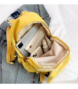 Interior view showing the large capacity of a yellow nylon chest bag with daily essentials