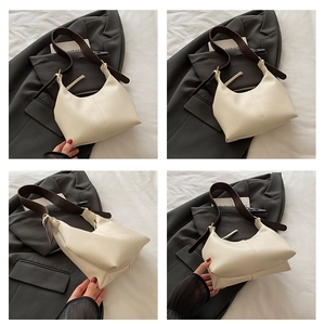Detailed views of creamy half-moon crossbody bag with brown strap and gold buckles
