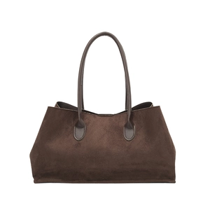 Retro deep brown suede leather tote bag with elegant teardrop strap details on white background