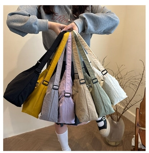 Detailed display of seven color variations for the minimalist nylon crescent tote bag