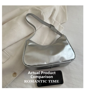 Detailed close-up of metallic silver crescent hobo bag with sleek faux leather texture