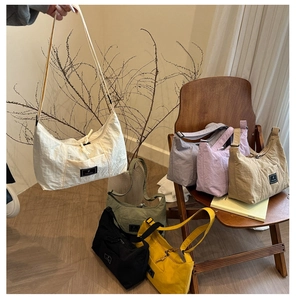 Multi-color nylon crescent shoulder bags with adjustable straps and zipper closure detail