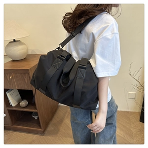 Detail of durable black nylon travel bag with reinforced handles and adjustable strap