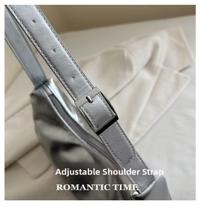 Close-up of the silver shoulder bag featuring an adjustable strap with a metal buckle