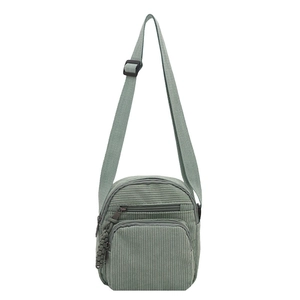Modern corduroy crossbody bag in sage green featuring an adjustable strap and dual zip pockets