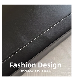Detailed macro view of black grainy leather texture and precise white contrast stitching