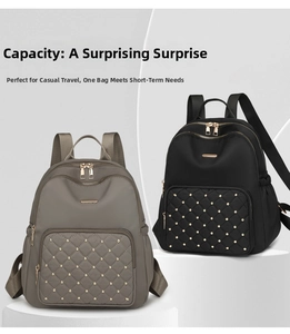 Detail of taupe and black nylon backpacks with quilted patterns and gold rivet accents