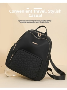 Detail of black nylon backpack with gold hardware and star-quilted zipper pocket