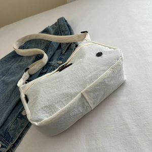 Waterproof white nylon crossbody bag with textured fabric and adjustable strap