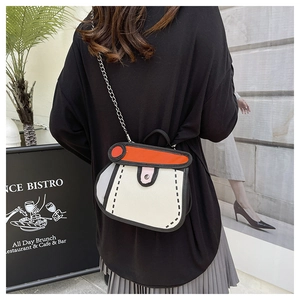 Close-up of 2D cartoon style crossbody bag with bold black outlines and metal chain
