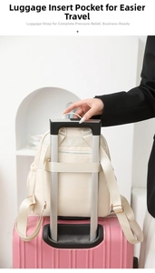 Detail view of the luggage strap on a beige nylon backpack attached to a suitcase handle