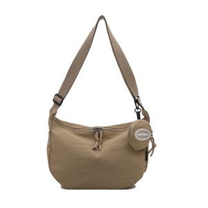 Khaki nylon crescent crossbody tote bag with adjustable strap and small round pouch charm