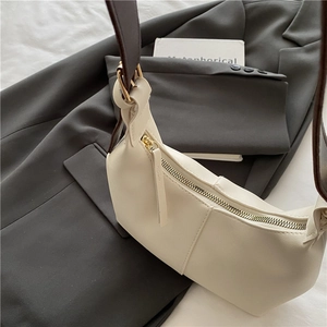 Fashionable cream white shoulder bag with contrast brown strap and gold metal hardware