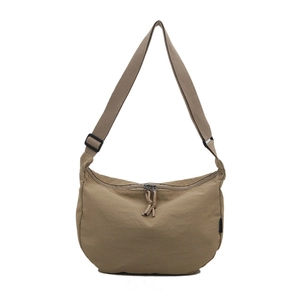 Minimalist khaki nylon half-moon crossbody bag with adjustable strap and dual zippers