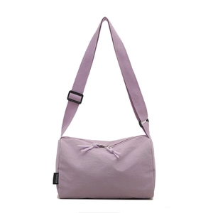Minimalist light purple nylon tote bag with wide shoulder strap and brand label on white background