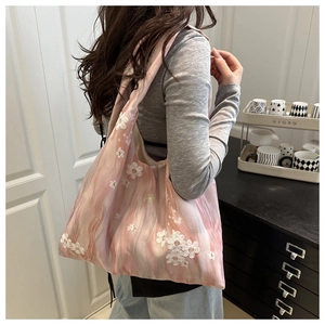 Detail of pink chiffon tote bag with floral lace embroidery and artistic dye pattern