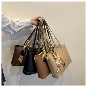 Multiple tote bags with vintage print scarves on handles in four trendy colors