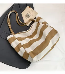 Close-up of brown and white striped canvas tote bag with thick fabric and dual handles