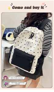 Detailed shot of white canvas backpack with black star print and contrast panels
