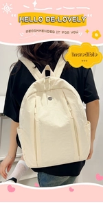 Detail view of lightweight off-white nylon backpack with functional multi-zipper design