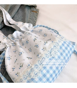 Detailed lace trim and floral checkered patchwork on the blue cotton drawstring tote bag