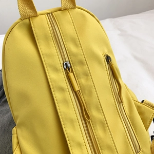 Waterproof yellow nylon backpack with dual resin zippers and durable carry handle