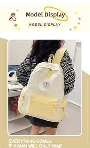 Close-up of yellow and white student backpack with star patterns and POLUCONI logo