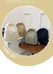 Group display of lightweight nylon backpacks in ivory, khaki, sage green and black