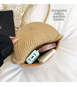 Detail of woven beige bag showing inner capacity for phone and cosmetics with gold clasp