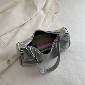Metallic silver underarm baguette bag with smooth mirror finish and wide strap