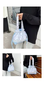 Detail of floral and checkered pattern tote with lace trim and drawstring closure