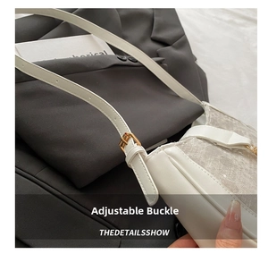 Close-up of white lace and leather shoulder bag with adjustable golden metal buckle