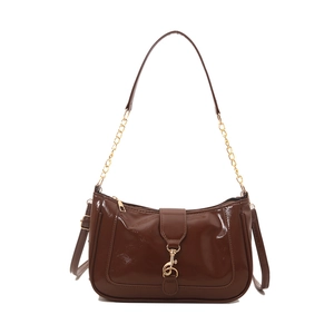 Glossy brown patent leather baguette bag with gold hook buckle and chain strap