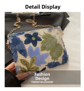 Detail of vintage floral embroidery and sequins on a white crossbody chain bag