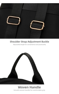 Detail of adjustable gold metal buckle and woven handle on black nylon backpack