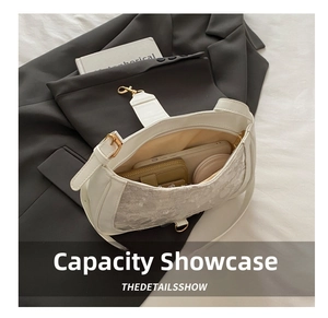 Practical capacity display showing a white lace baguette bag with phone and wallet