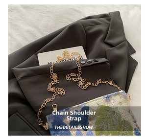 Detail of floral sequin embroidery on an evening clutch bag with gold chain strap
