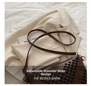 Close-up of adjustable strap design and black studs on brown leather handbag