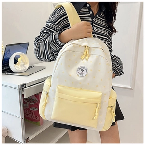 Close-up of student canvas backpack featuring yellow star patterns and embroidery