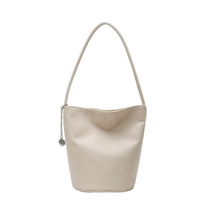 Chic cream pebble leather bucket bag with silver charm and large capacity for women