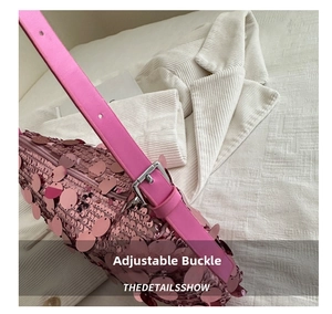 Close-up detail of the adjustable buckle on the pink sequin shoulder bag strap