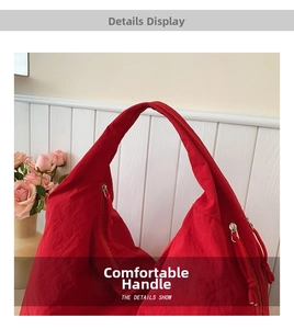 Detail shot of the red tote bag showing crinkled nylon fabric texture and metal zipper