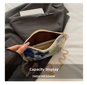 Macro view of blue floral sequins clutch bag showing interior capacity and golden chain