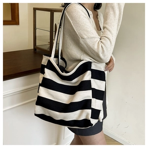 Detail of black and white striped canvas tote bag with thick shoulder straps for daily use