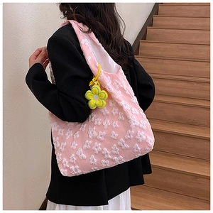Pink floral tote bag featuring 3D embossed flowers and sunflower charm on a model