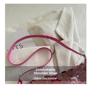 Detail of pink sequin shoulder bag showing smooth leather strap and sparkling texture
