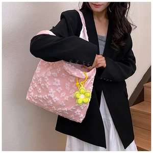 Chic pink tote bag with white floral lace embroidery and a sunflower charm decoration