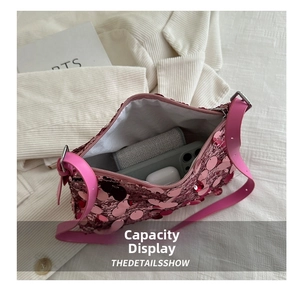 Internal view of a pink sequin shoulder bag showing capacity for phone and cosmetics