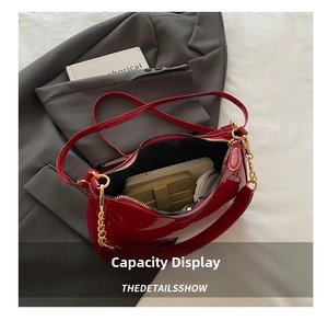 Interior capacity of red patent leather shoulder bag with wallet, phone and daily items
