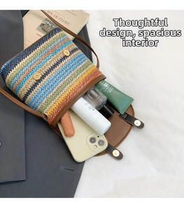 Detailed interior of striped woven crossbody bag showing capacity for phone and cosmetics
